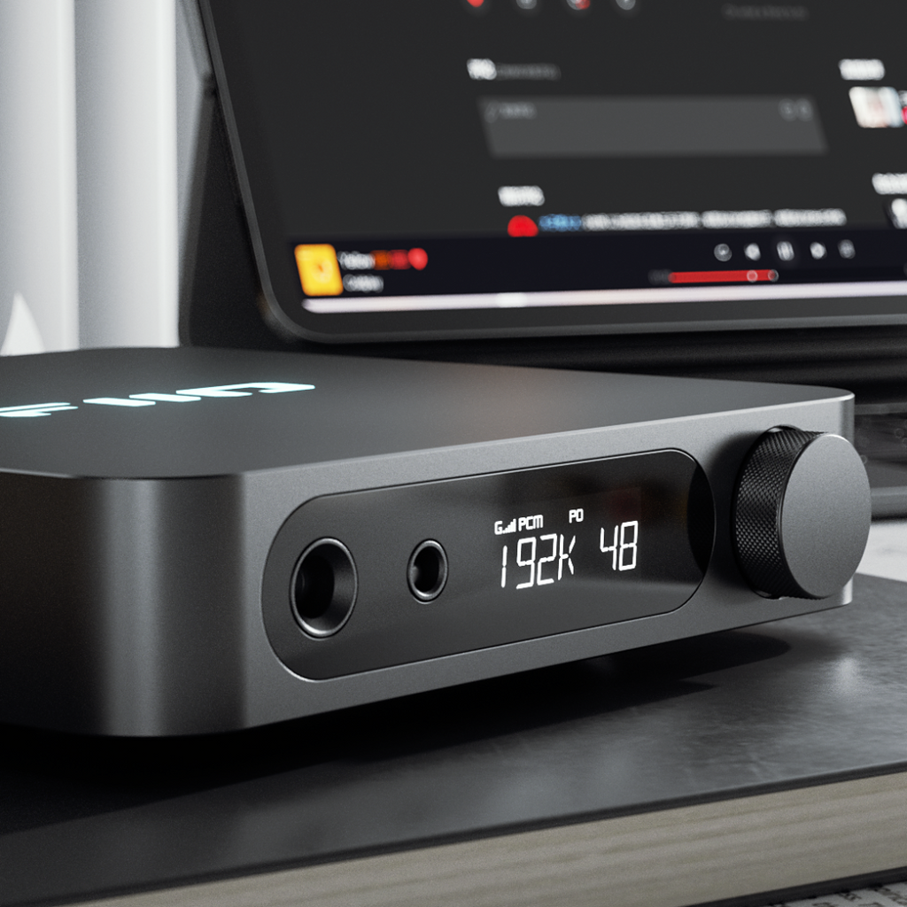 FiiO K11 headphone amplifier and DAC, in black, lifestyle setting