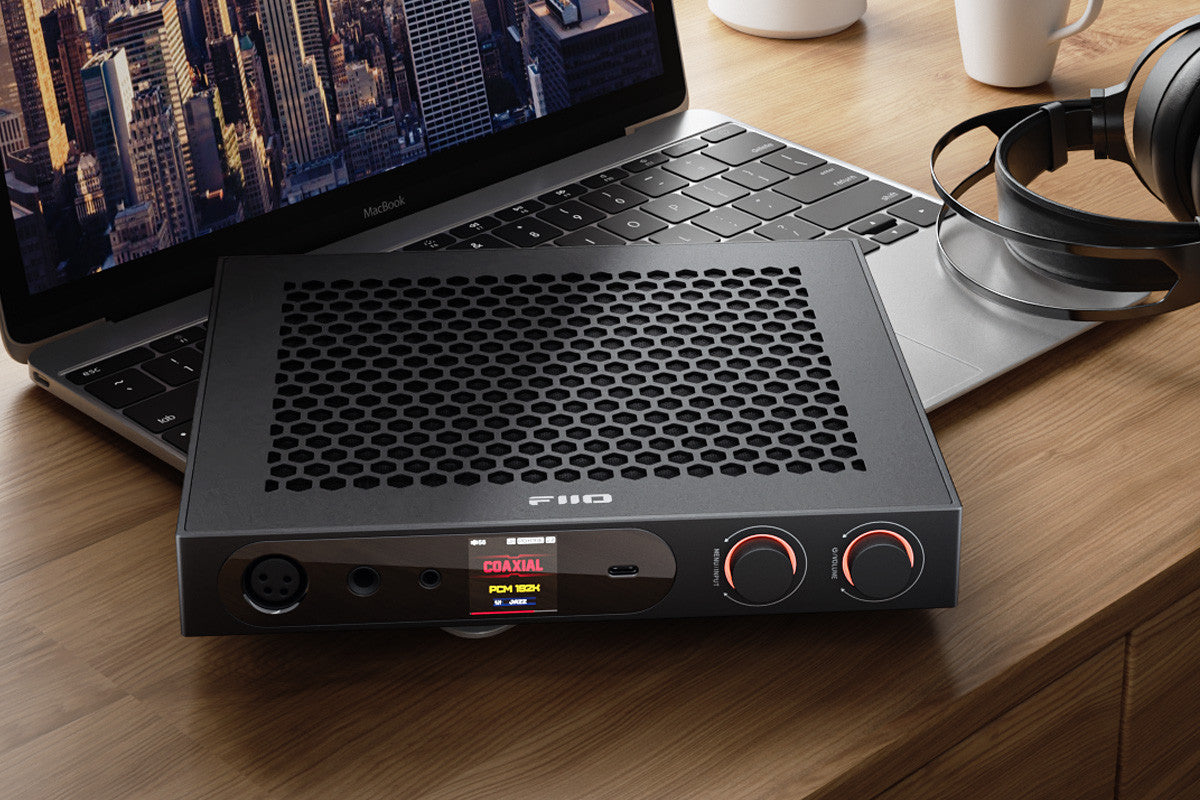 FiiO K19 black headphone amplifier and DAC with USB connection, featuring sleek design and high-quality audio components.