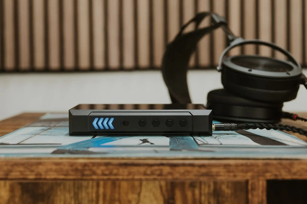 FiiO M23 portable music player shown in a lifestyle setting, featuring a sleek design and high-resolution display.