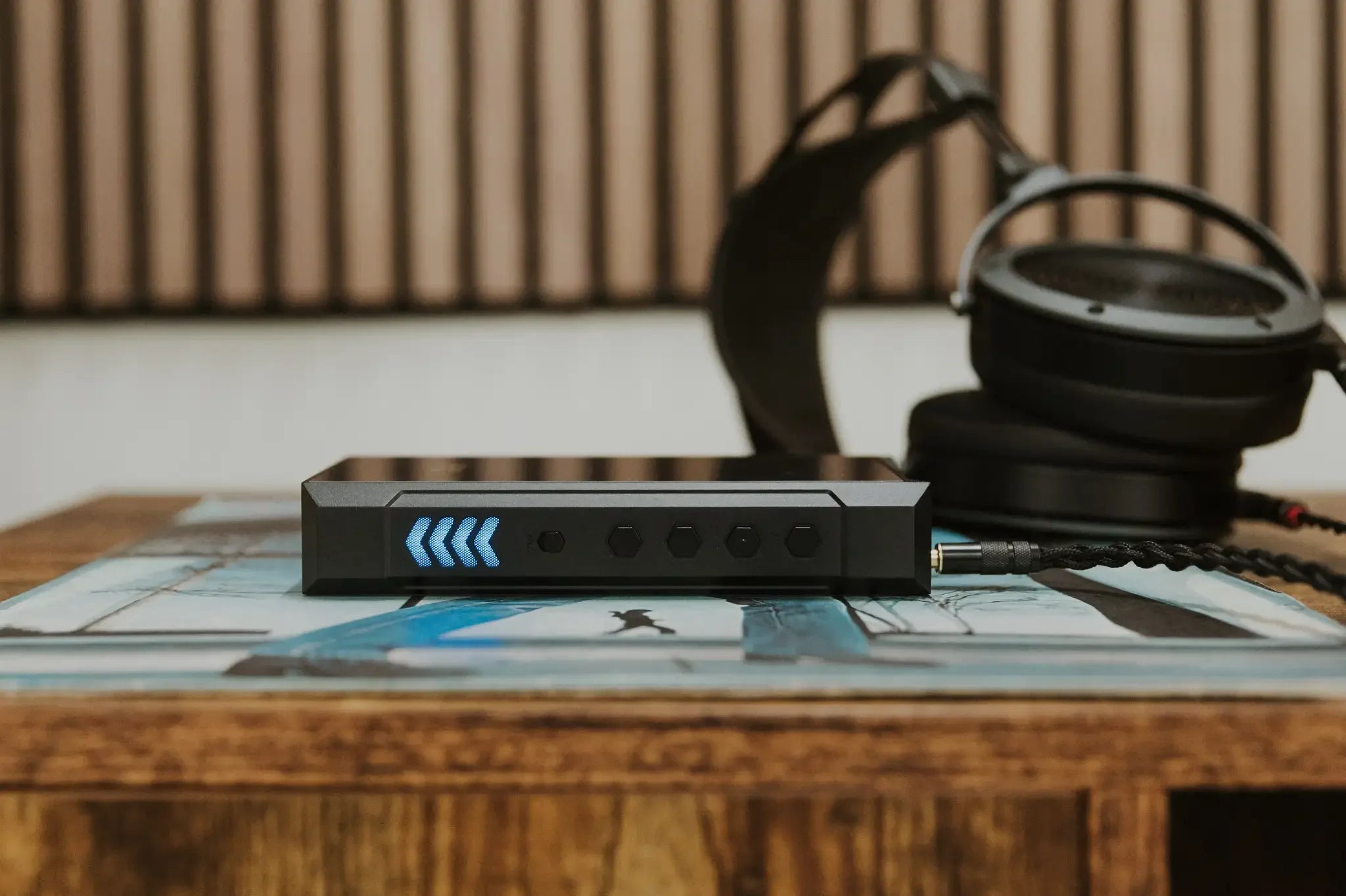 FiiO M23 portable music player shown in a lifestyle setting, featuring a sleek design and high-resolution display.