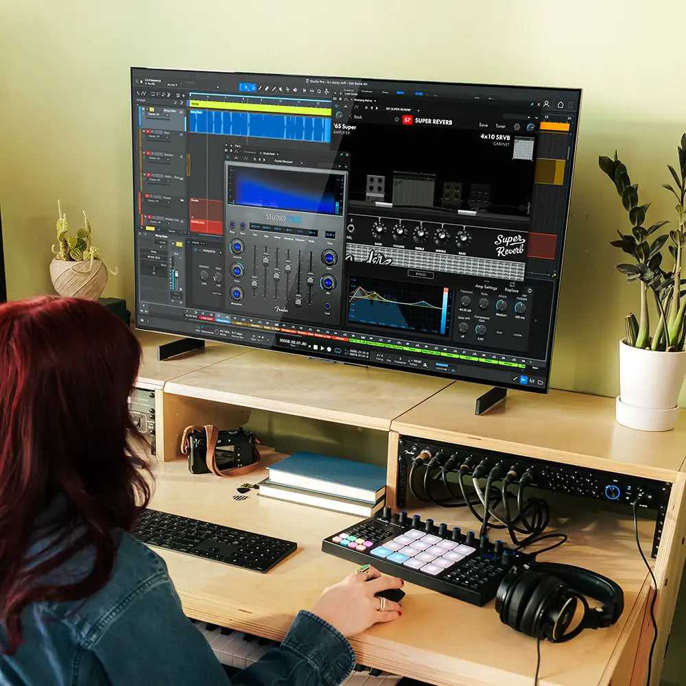 Fender Motion 16 MIDI controller with colorful pads and knobs, shown connected to a laptop in a creative music setup.
