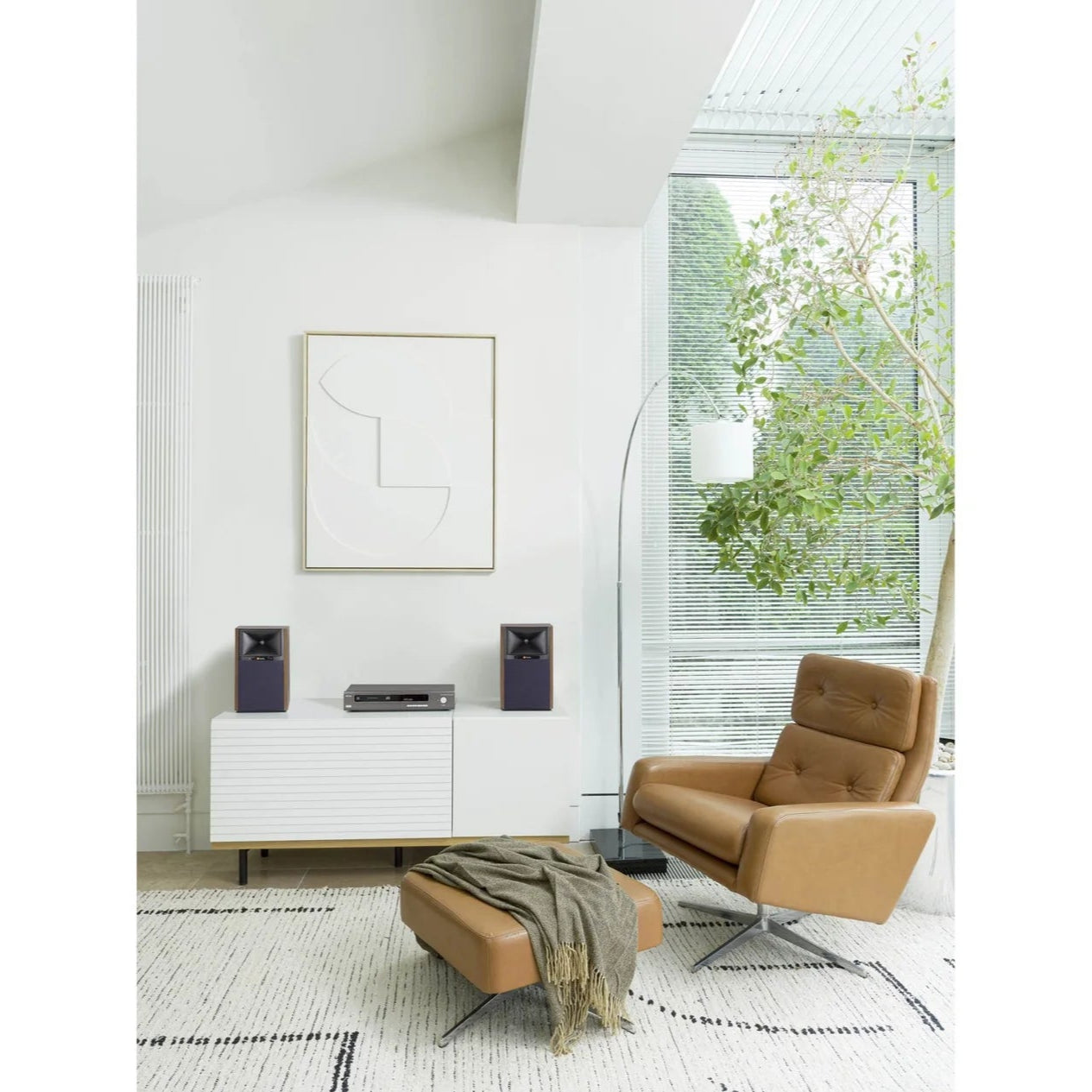 JBL 4305P active bookshelf speakers with black finish and modern design, shown from a slight side angle.