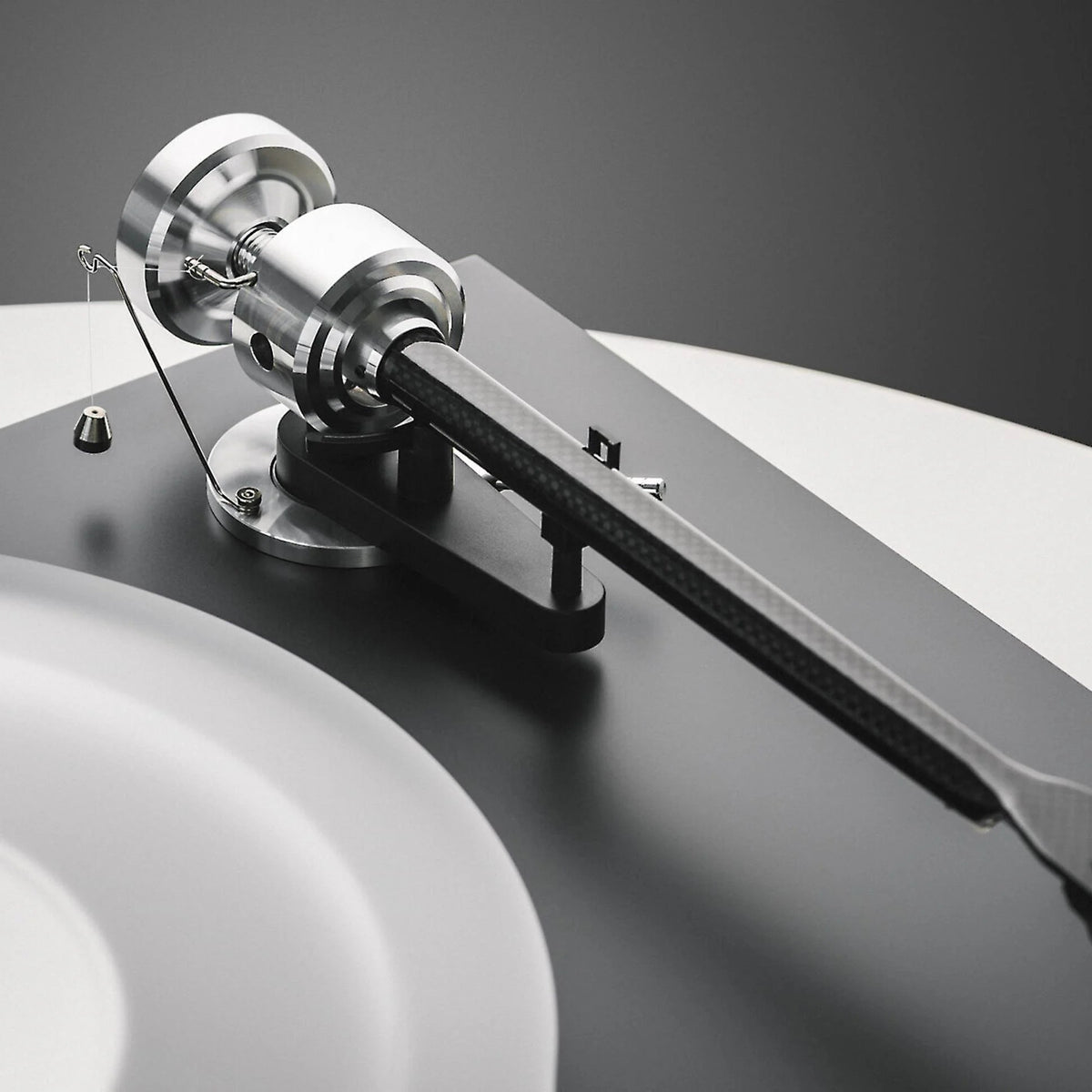 Pro-Ject Debut Reference 10 manual turntable with sleek design, featuring a tonearm and platter for high-quality vinyl playback.