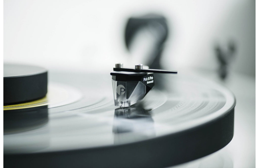 Pro-Ject XA B turntable with sleek wooden plinth and tonearm, showcasing high-quality audio equipment for vinyl listening.