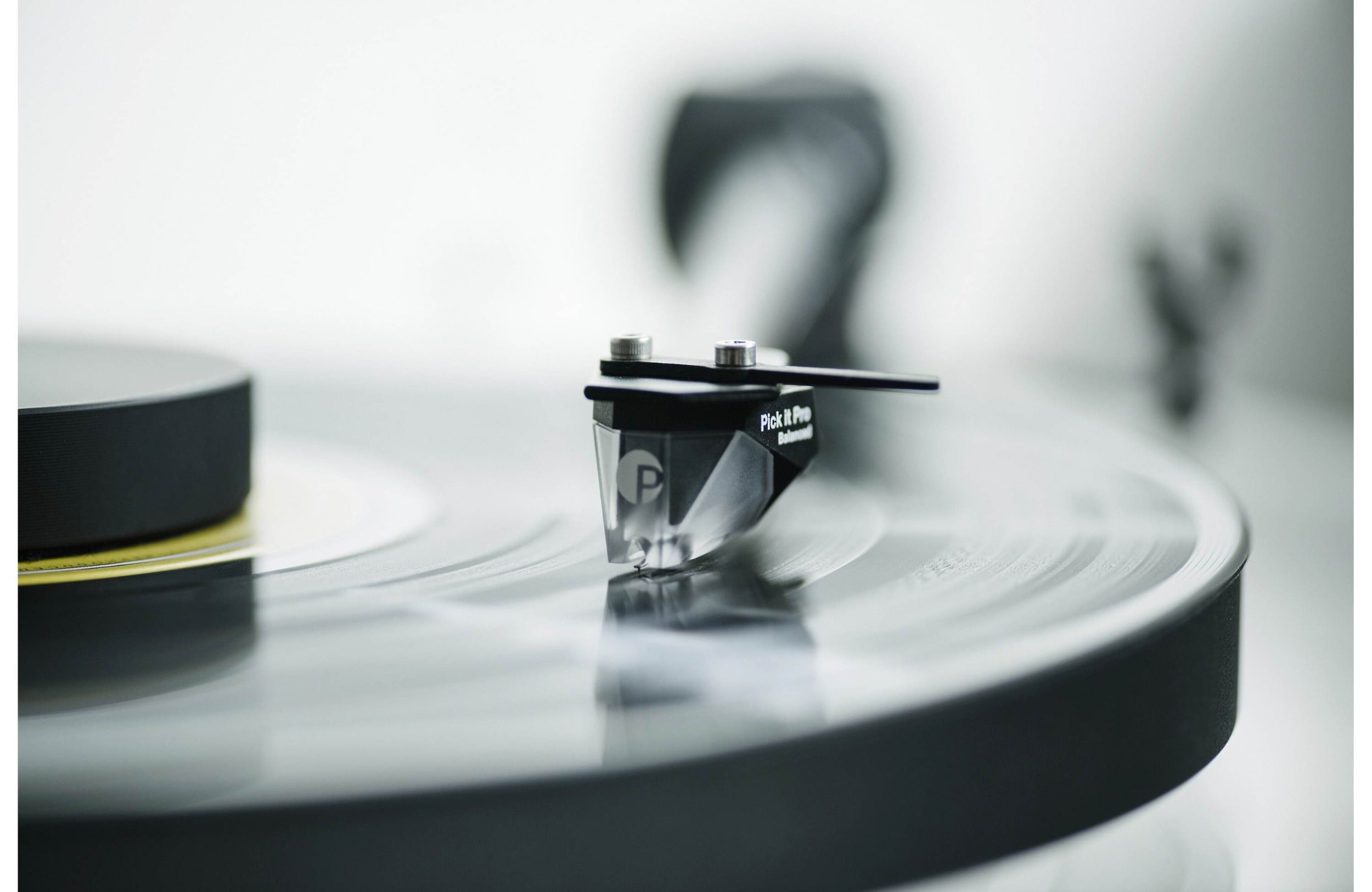 Pro-Ject XA B turntable with sleek wooden plinth and tonearm, showcasing high-quality audio equipment for vinyl listening.