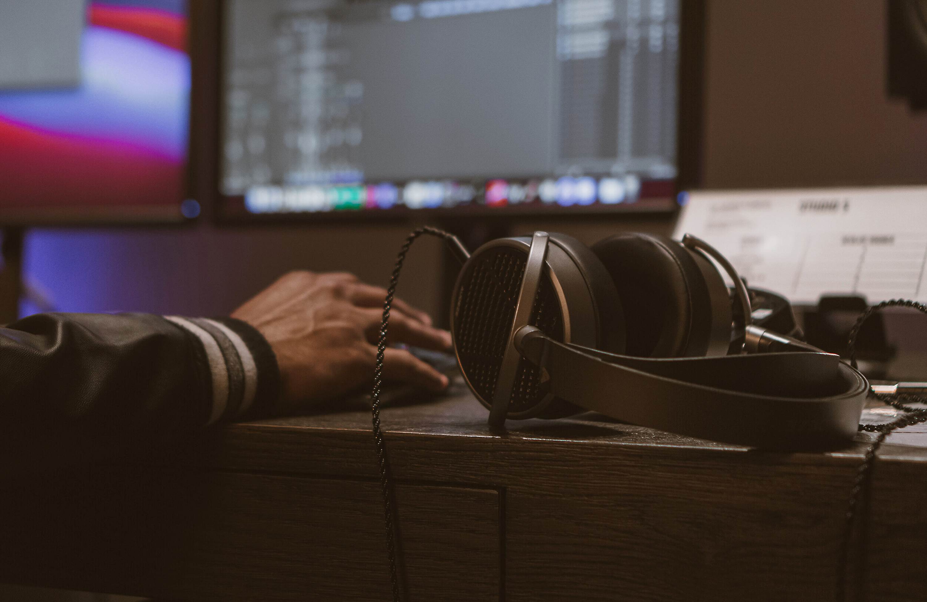 Audeze MM-100 studio headphones with over-ear design, featuring black earpads and sleek headband for professional audio monitoring.
