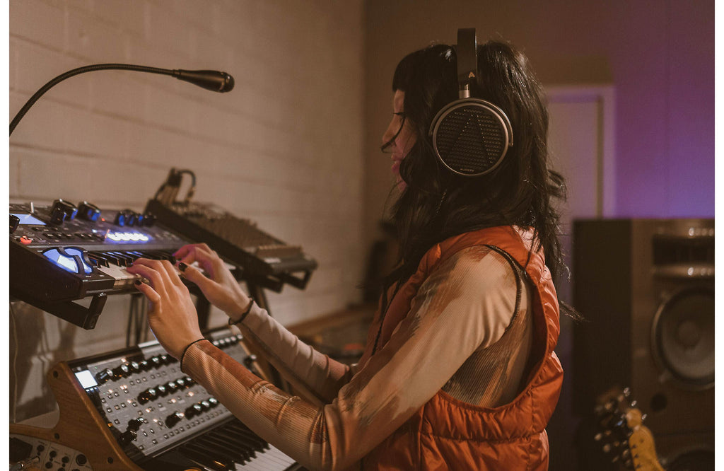 Audeze MM-100 studio headphones with over-ear design, black color, and padded ear cups for professional audio monitoring.