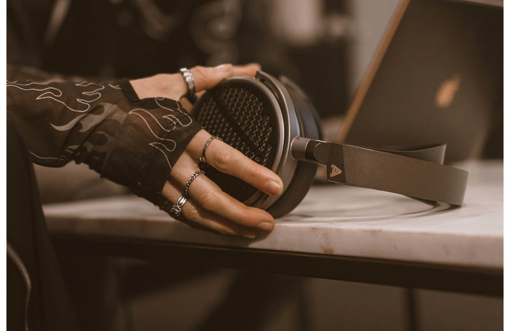 Audeze MM-100 studio headphones with over-ear design and sleek black finish, designed for professional audio monitoring.