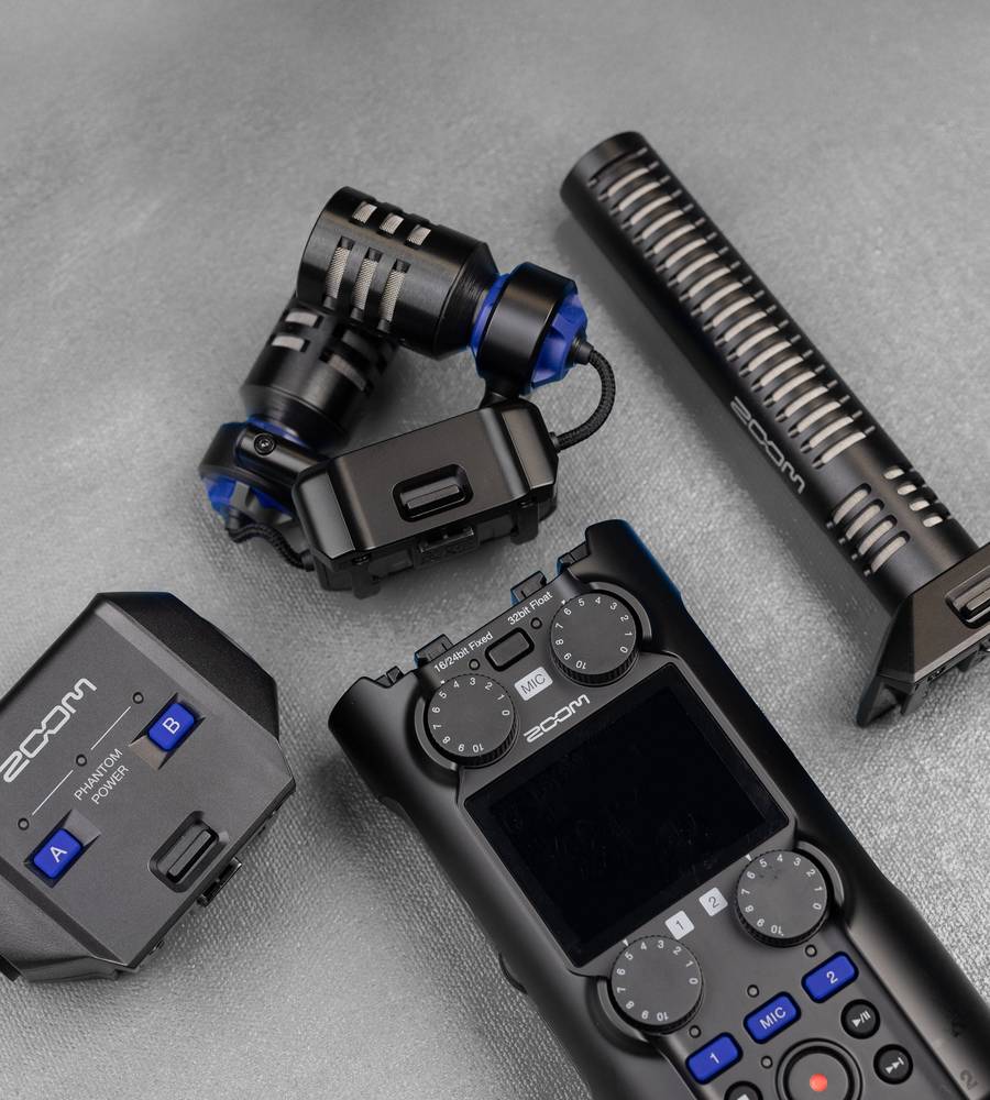 Zoom H5 Studio digital recorder with detachable capsules and multiple input options, shown with its accessories and controls.