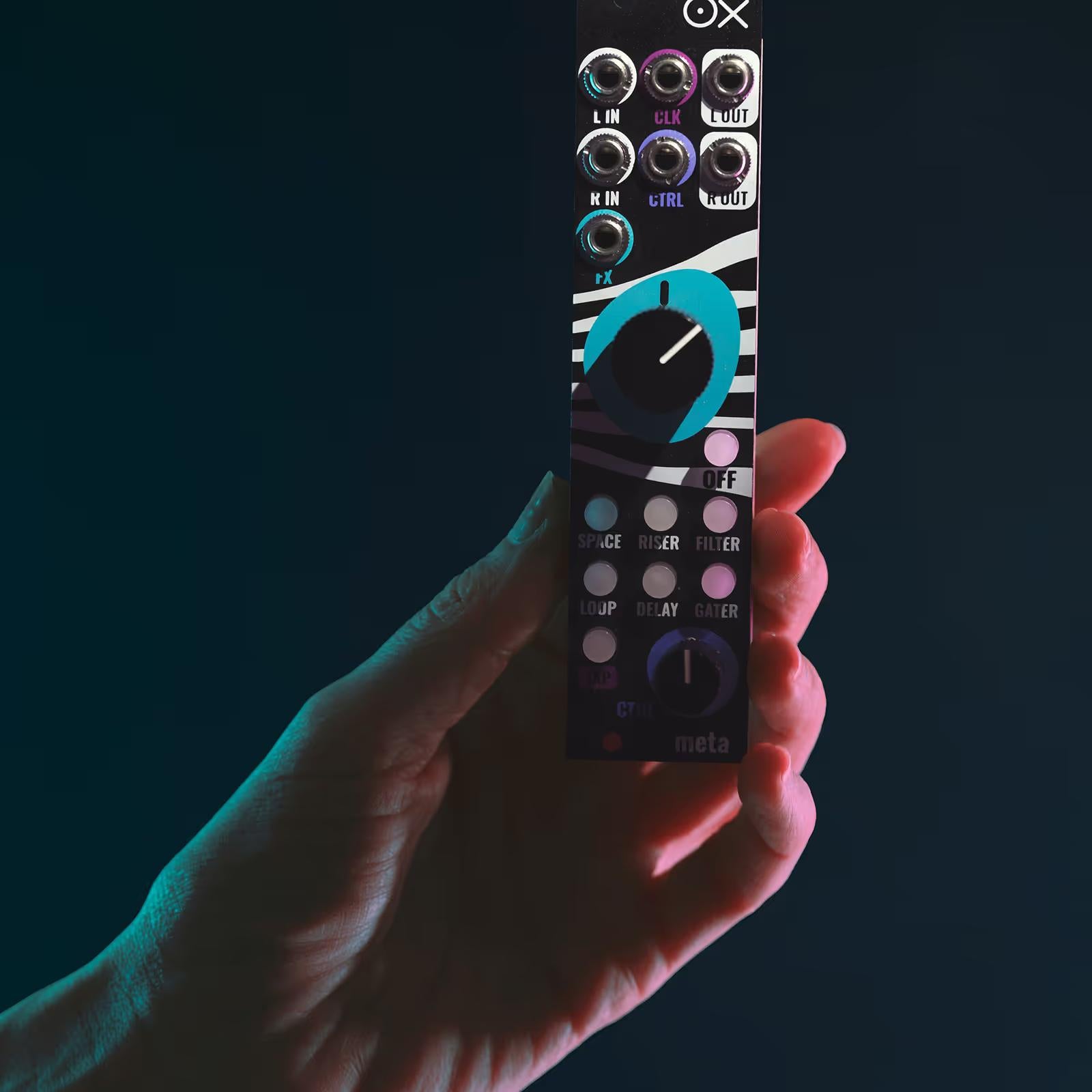 Close-up of a hand adjusting controls on the OXI Instruments Meta semi-modular synthesizer.
