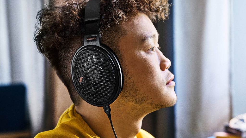 Sennheiser HD 660S2 open-back headphones with over-ear design and premium ear cups, displayed on a stand.