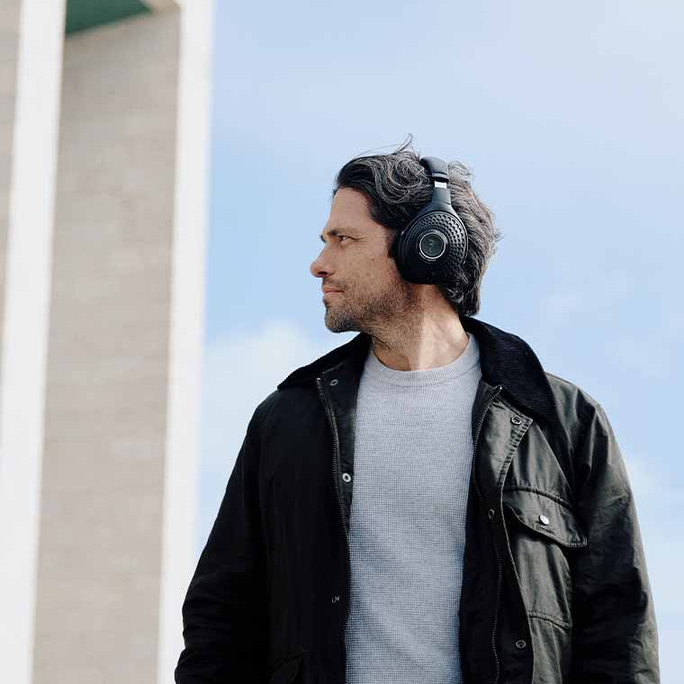 Focal Bathys wireless headphones worn by a man, featuring deep black over-ear design with sleek, modern style.