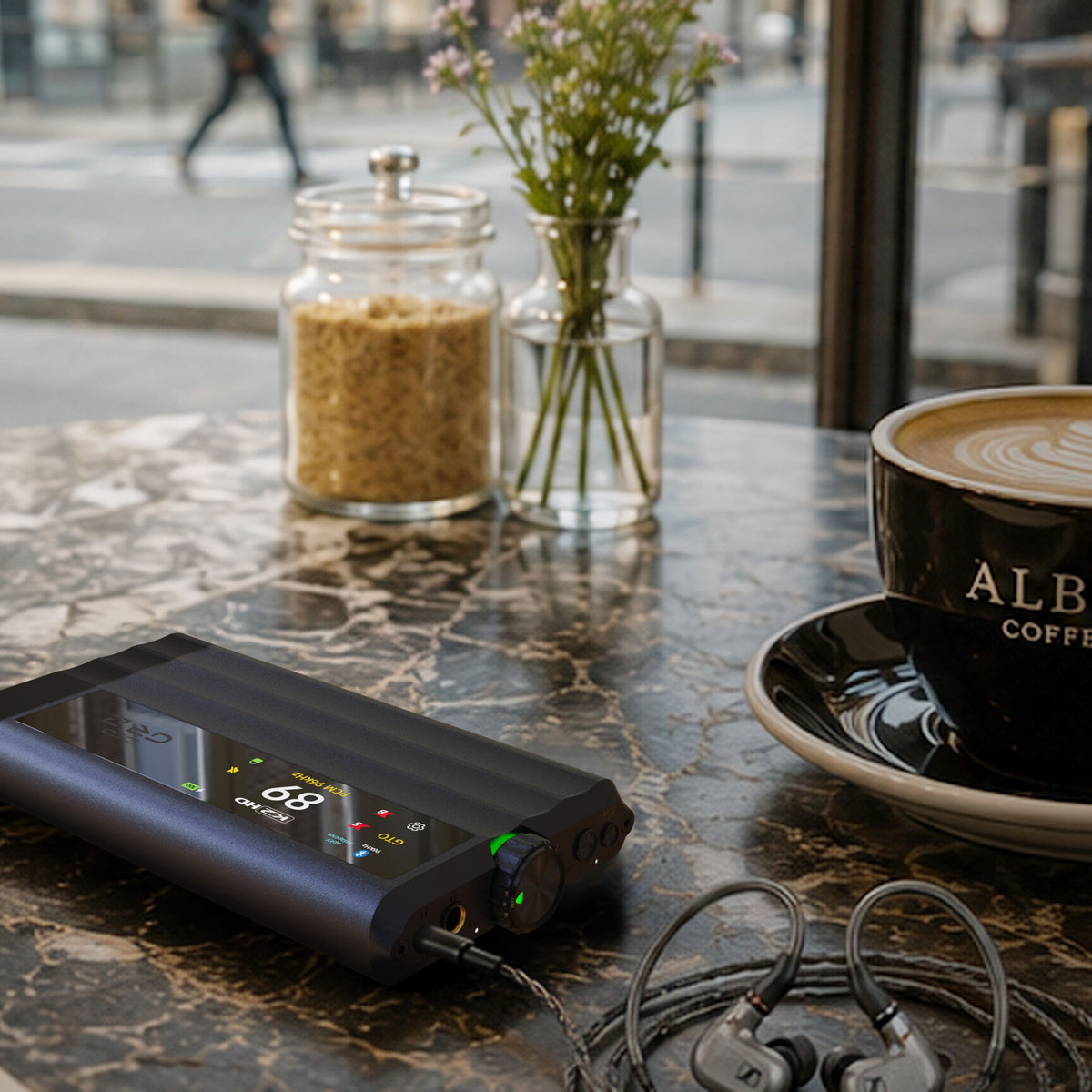 iFi Audio iDSD GR 2 portable DAC on a marble cafe table with Sennheiser IEMs and coffee