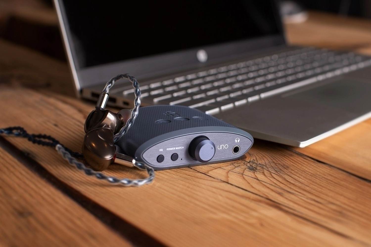 iFi Audio Uno headphone amplifier and DAC with compact design and multiple connection options, featuring a sleek black finish.