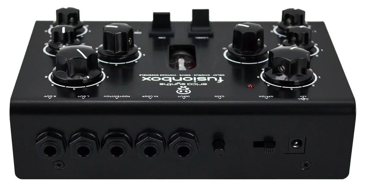 Erica Synths Acidbox III effects pedal with control knobs and input/output jacks, used for acid-style bass and synth sounds.