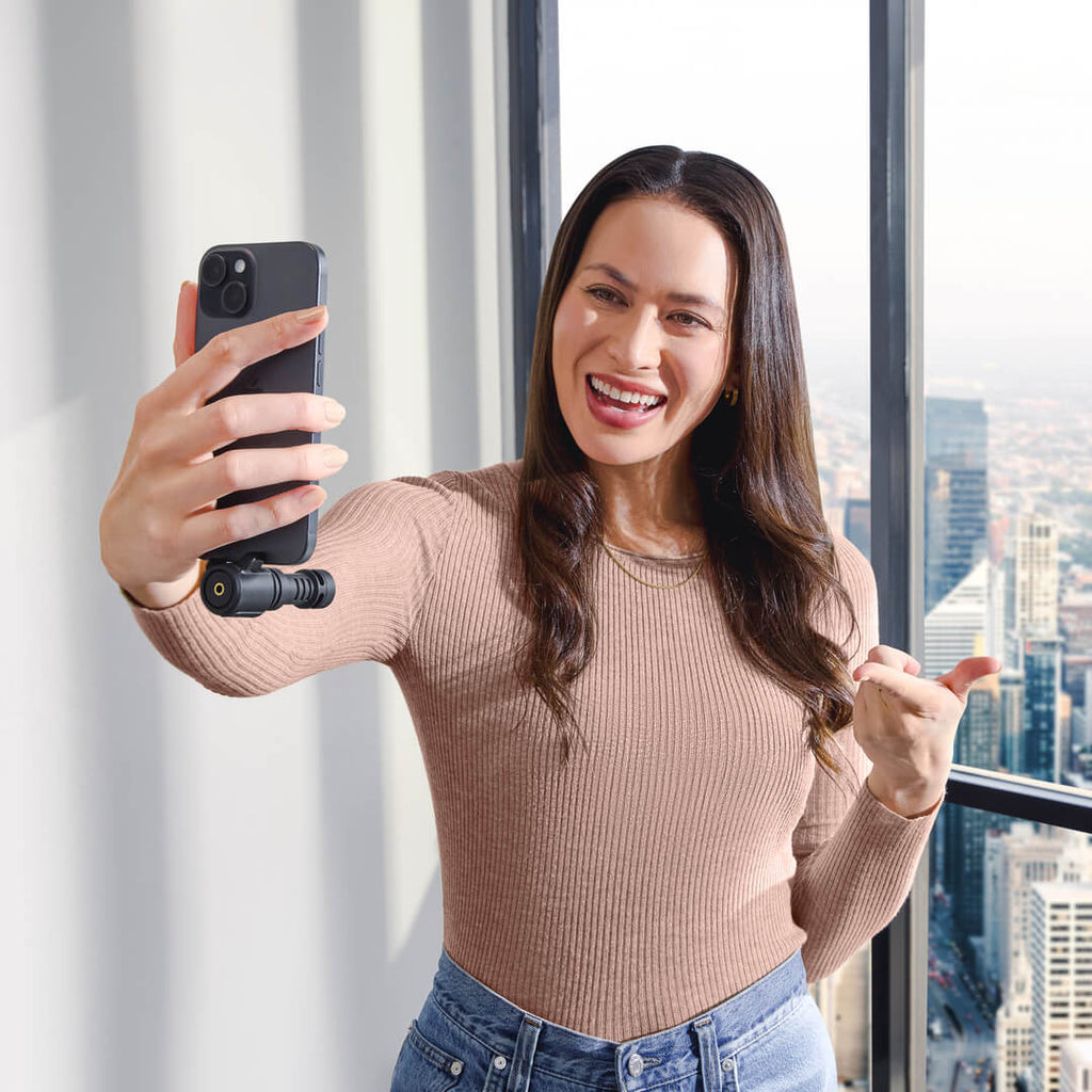 Rode VideoMic ME-C+ in use, compact iOS & Android microphone with built-in controls and Rode branding, capturing audio clearly.