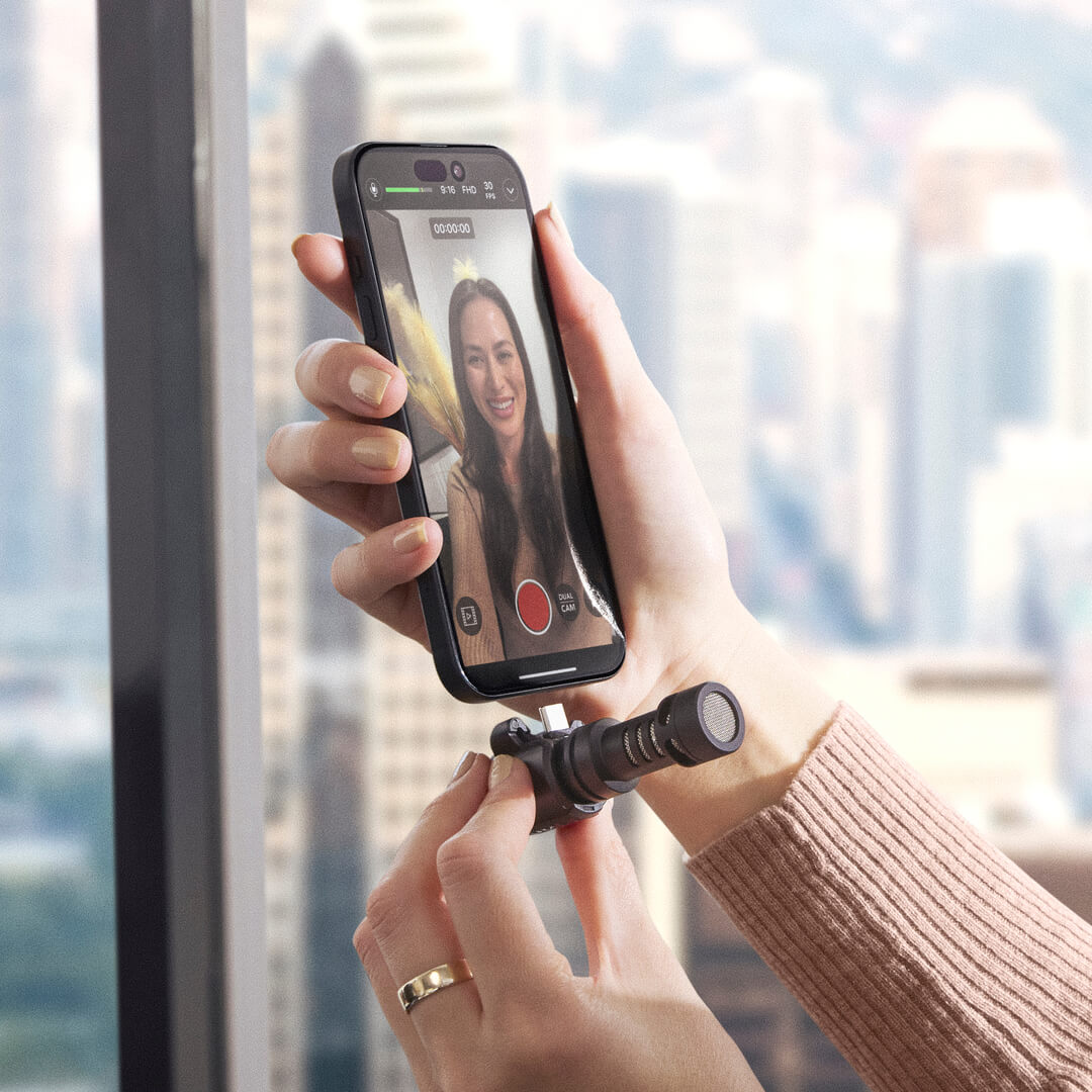 Rode VideoMic ME-C+ portable microphone plugged into a smartphone, designed for iOS and Android devices for high-quality audio recording.