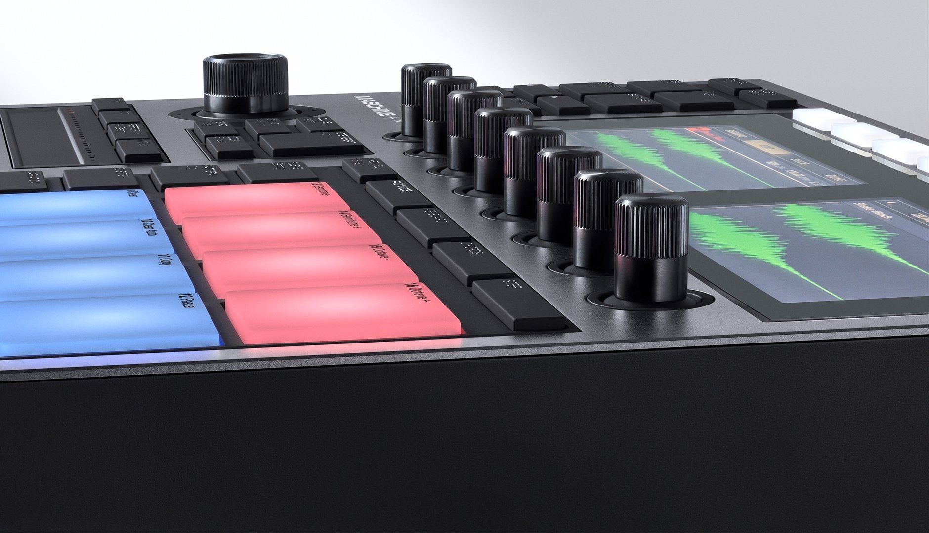Native Instruments Maschine+ drum machine and sampler with pads, knobs, and display for music production.