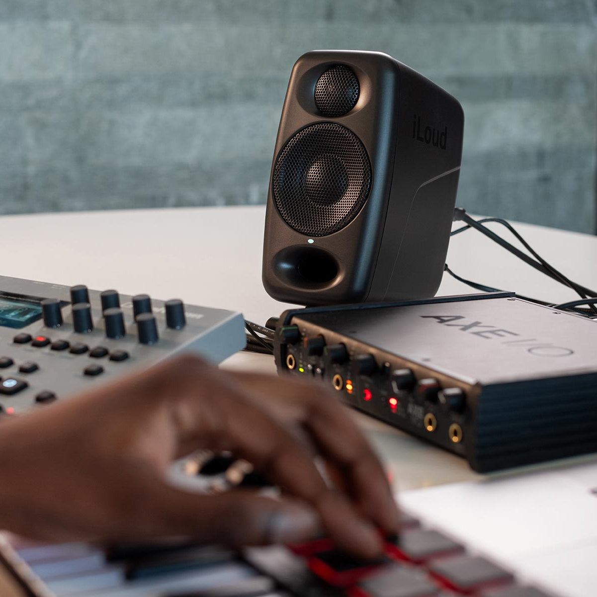 IK Multimedia iLoud Micro Monitor Pro active nearfield monitor speakers with sleek black design and controls visible.
