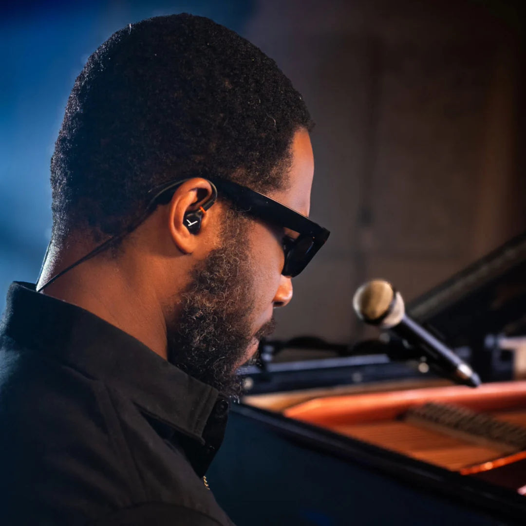 Beyerdynamic DT 73 IE studio in-ear headphones on stage, showing detailed earbud design and in-ear fit for professional audio.