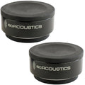 IsoAcoustics ISO-Puck studio monitor stand isolation pads on a surface, designed to improve audio clarity and reduce vibrations.