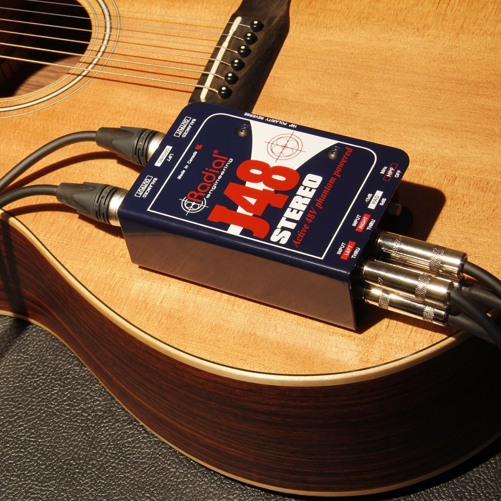 Stereo Radial Engineering J48 DI box connected to audio equipment, showcasing its professional design and input/output connections.