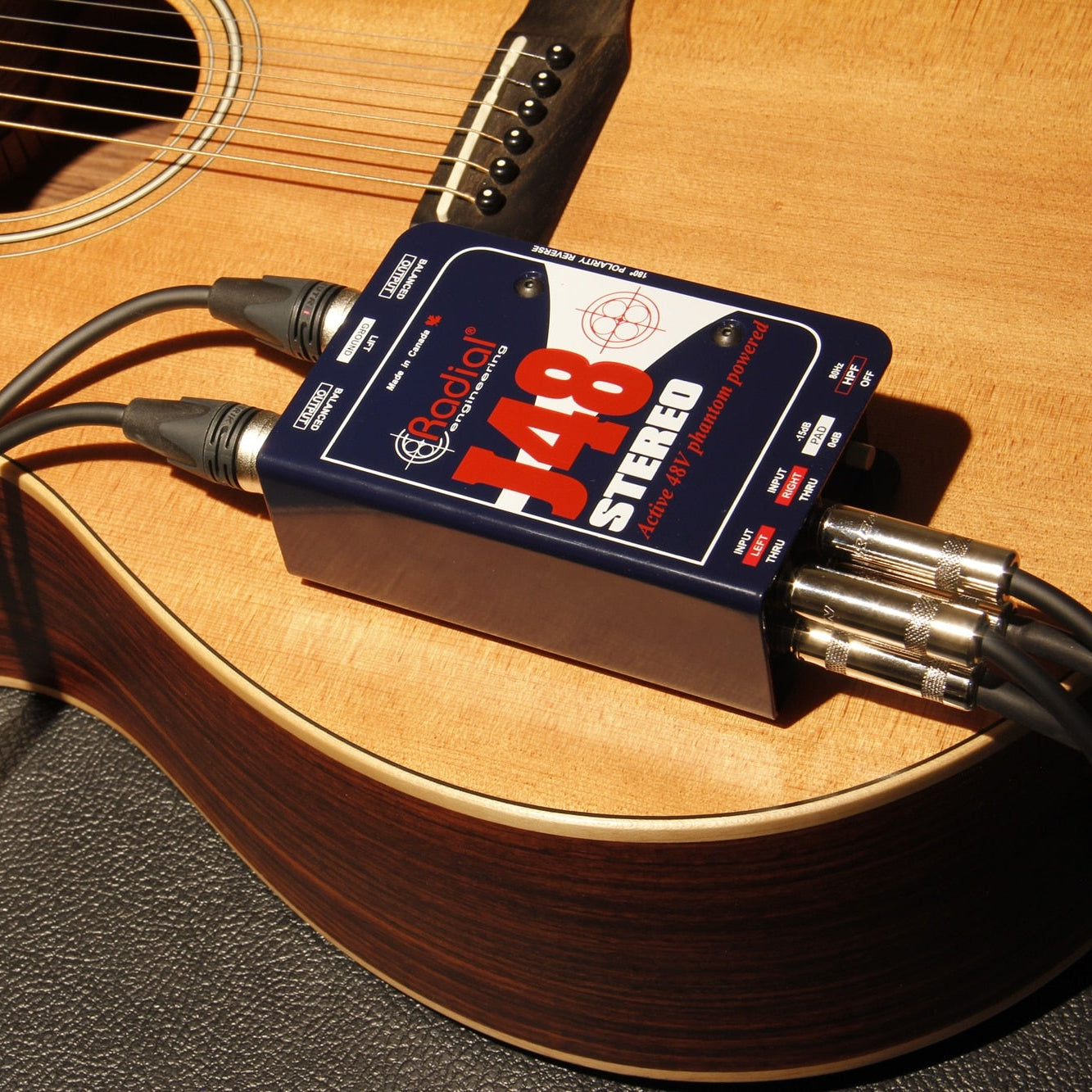 Stereo Radial Engineering J48 DI box connected to audio equipment, showcasing its professional design and input/output connections.