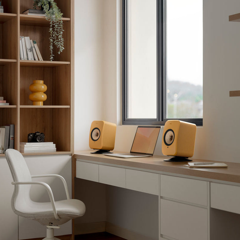 KEF LSX II wireless bookshelf speakers, in amber haze and cotton white