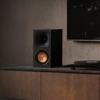 Klipsch RP-500PM powered speaker, front three-quarter angle next to a turntable
