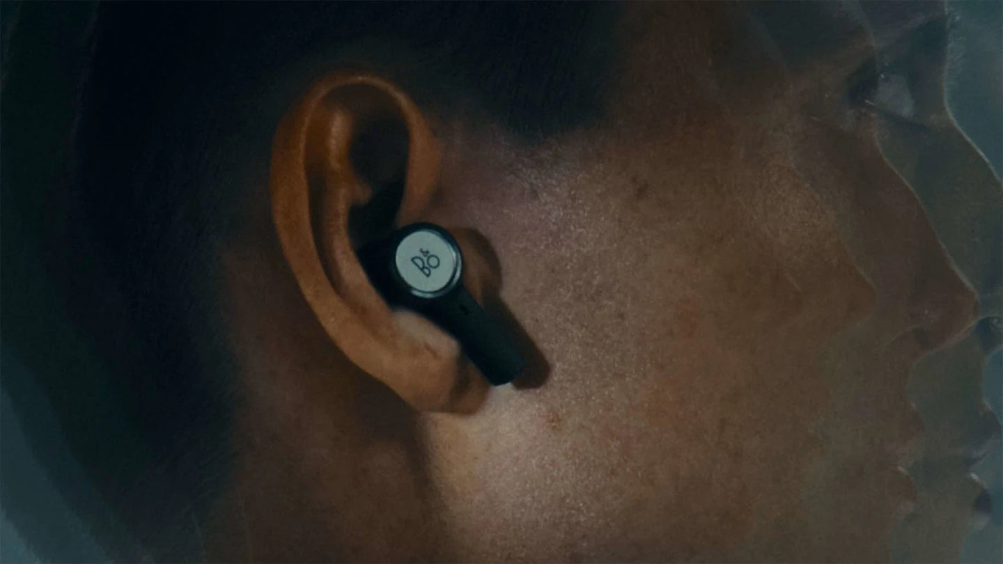 Wireless in-ear headphones from Bang & Olufsen Beoplay Eleven, shown in a lifestyle setting with call quality and sleek design.