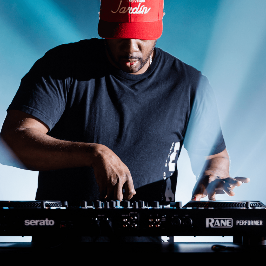 Rane Performer DJ controller with dual jog wheels, mixer controls, and colorful LED lighting for professional DJ performances.