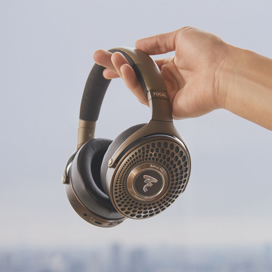 Focal Bathys MG wireless headphones with over-ear design, black finish, and cushioned ear cups, shown from the front angle.