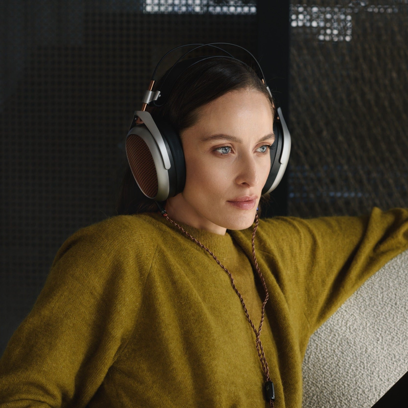 Meze Audio Poet wired headphones with sleek design and over-ear cushions, featuring black and silver accents.