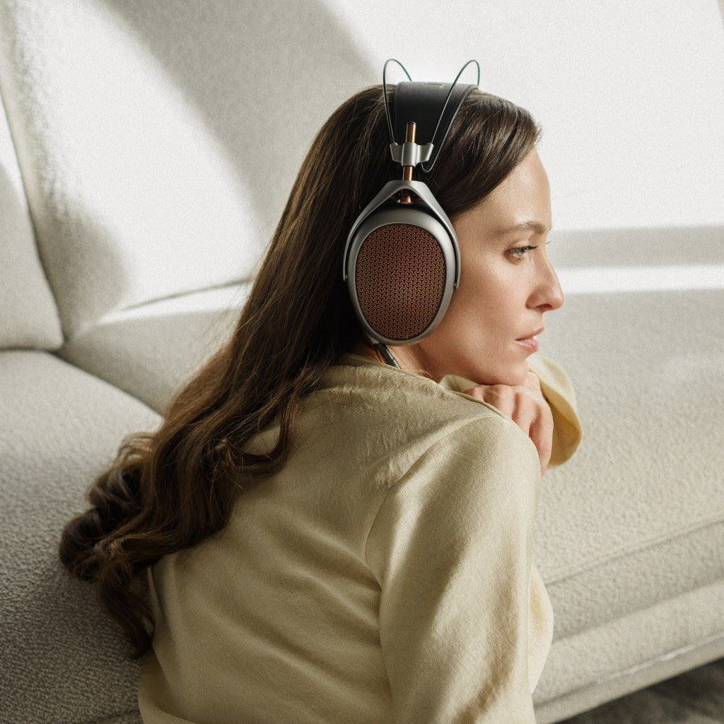 Wired Meze Audio Poet headphones with black ear cups and silver accents, featuring a sleek design and adjustable headband.
