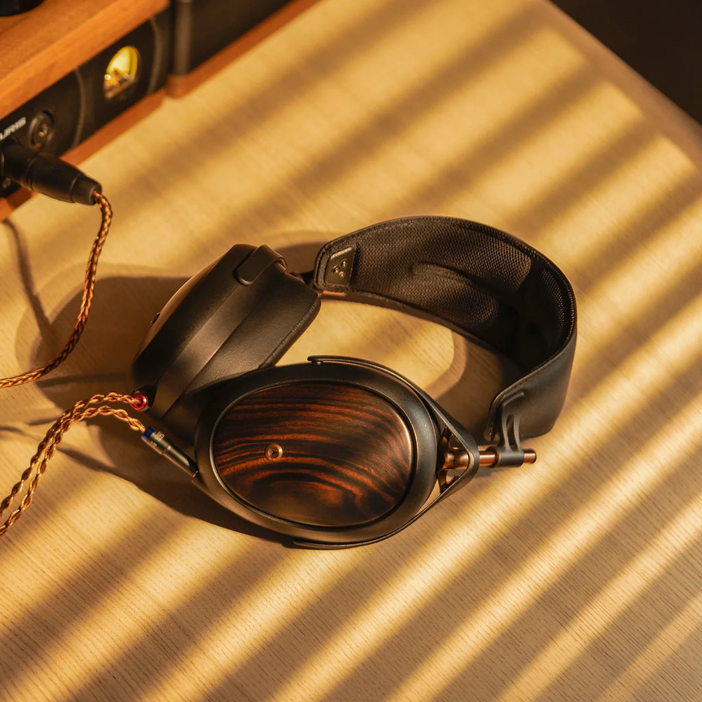 Meze Audio Liric wired headphones with sleek black ear cups and silver accents, showing the headband and ear cushions.