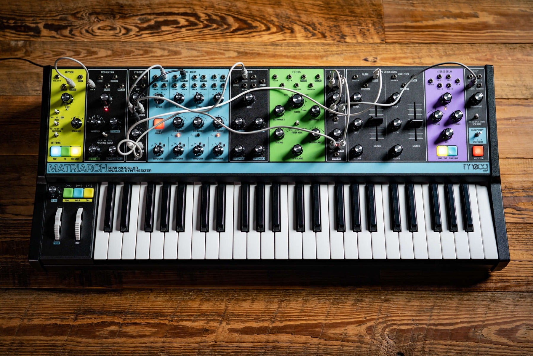 Moog Matriarch synthesizer with multiple knobs, patch points, and keyboard, showcasing its analog electronic music production interface.