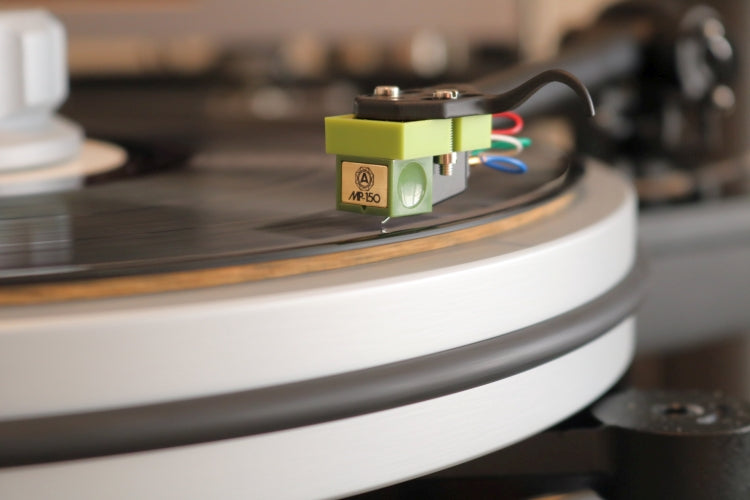 Nagaoka MP-150H turntable cartridge with headshell, mounted on a record player stylus and tonearm for high-quality audio playback.