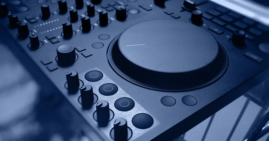 Native Instruments Traktor MX2 DJ controller with multiple knobs, faders, and buttons for professional music mixing and DJing.
