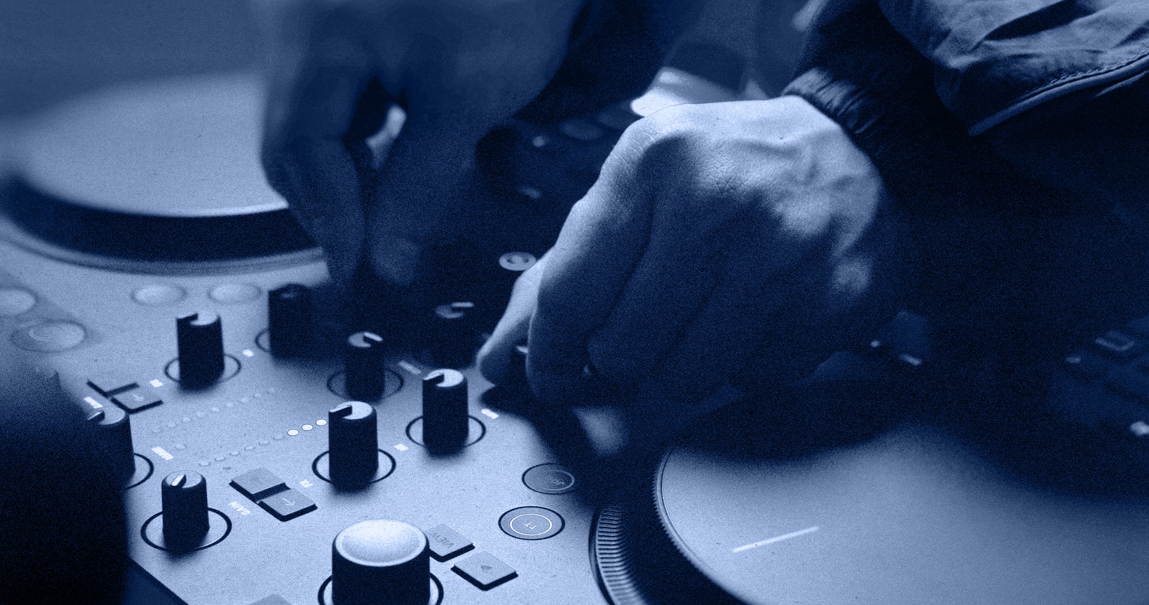 Native Instruments Traktor MX2 DJ controller with jog wheels, faders, and controls for professional DJ mixing.