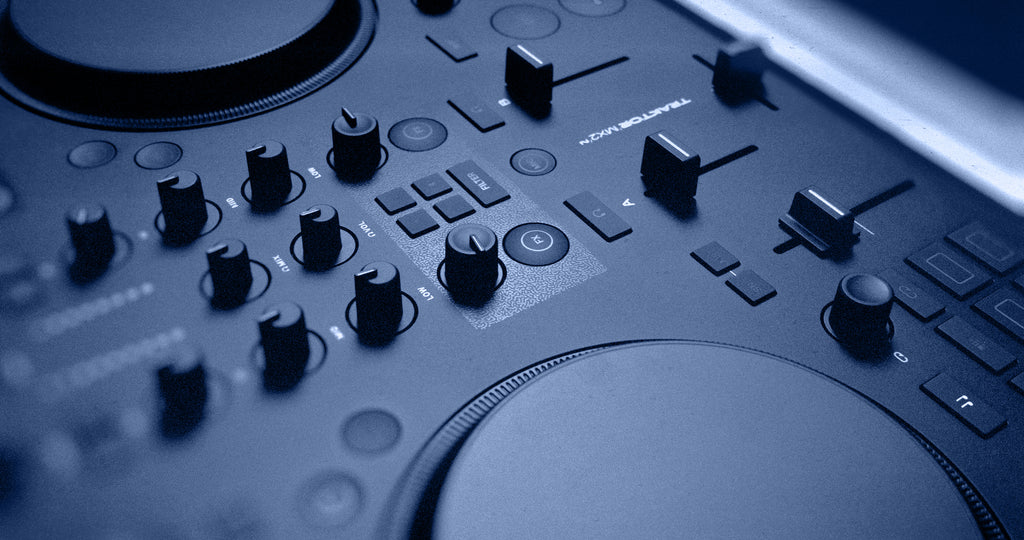 Native Instruments Traktor MX2 DJ controller with dual jog wheels, faders, and control knobs for professional DJ mixing.