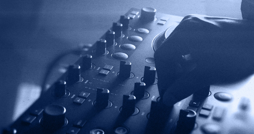 Native Instruments Traktor MX2 DJ controller with dual jog wheels, mixer knobs, and performance pads for professional DJ mixing.