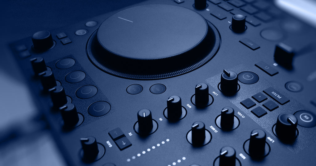Native Instruments Traktor MX2 DJ controller with dual jog wheels, mixer knobs, and performance pads for digital DJing.