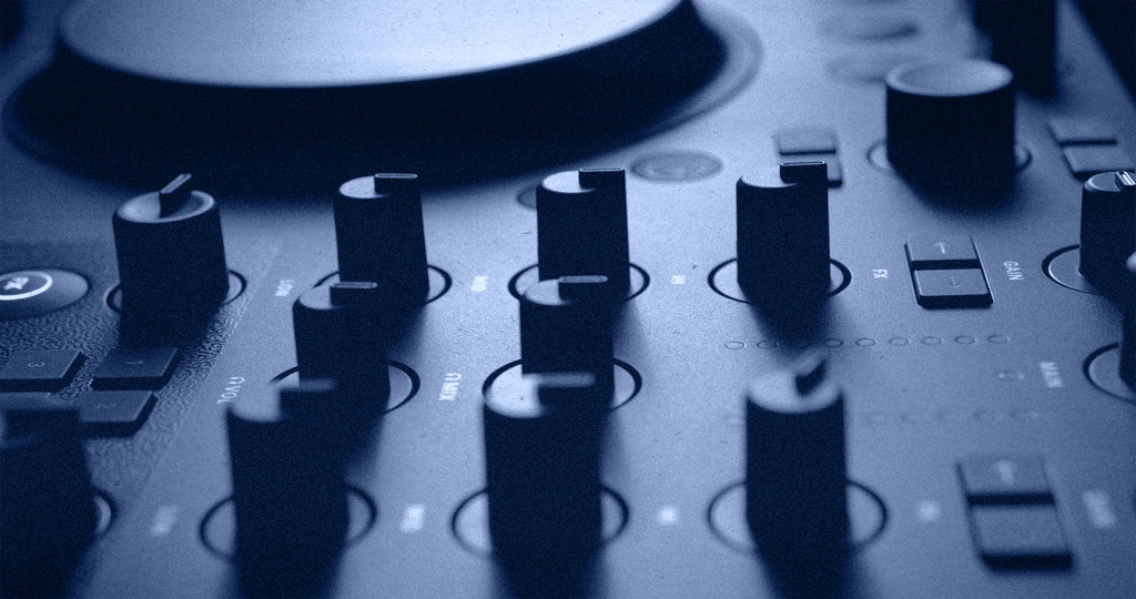 Native Instruments Traktor MX2 DJ controller with dual jog wheels, mixer controls, and colorful LED lighting for DJ mixing.
