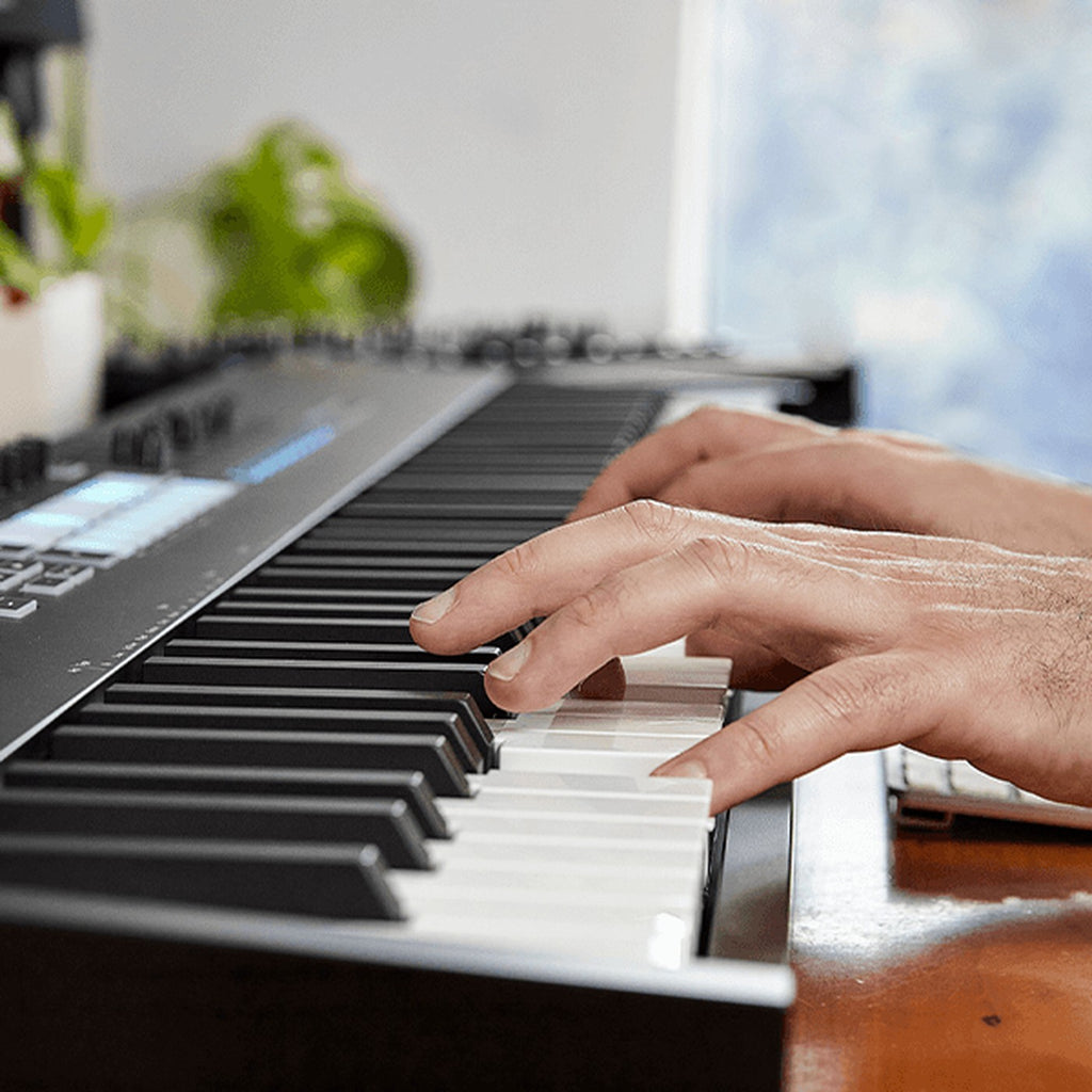 Hands playing the Novation Launchkey 88 MK4 keys
