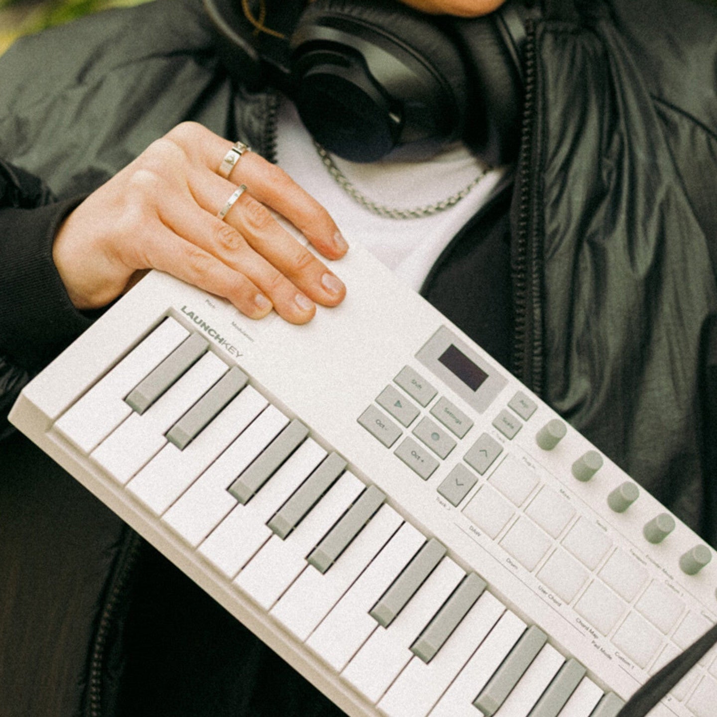 Novation Launchkey Mini 37 MK4 MIDI keyboard, in white, lifestyle setting, with case