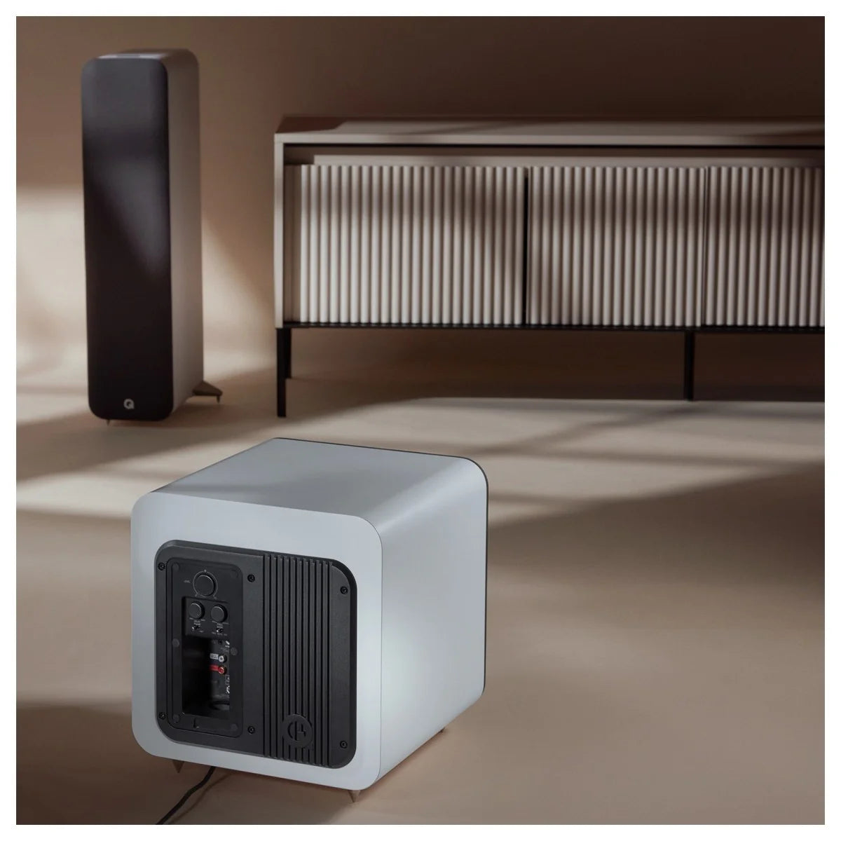 Q Acoustics Q SUB80 subwoofer with sleek black finish and compact design, showcasing its modern speaker grille and connection ports.