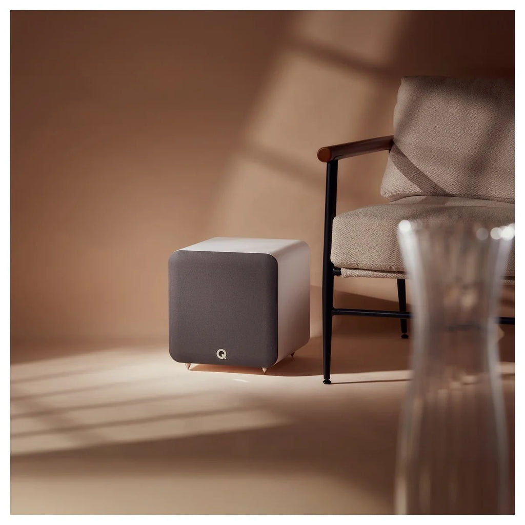 Q Acoustics Q SUB80 subwoofer showing a sleek black design with a textured finish and a circular speaker grille.