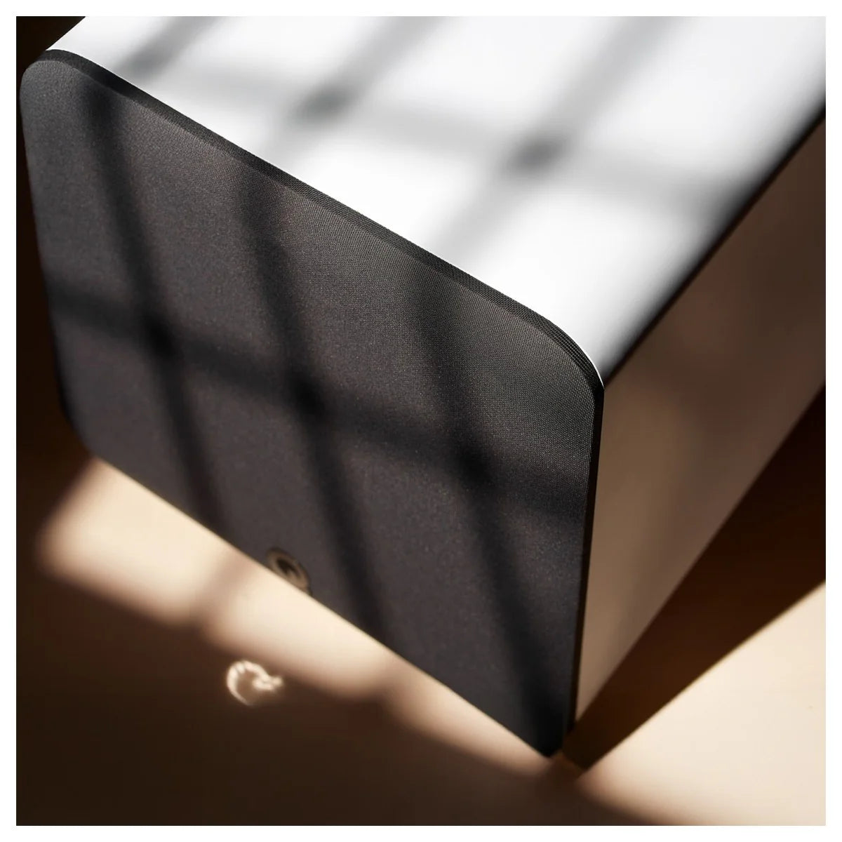 Q Acoustics Q SUB80 subwoofer with sleek black design and compact size, showcasing its front grille and control panel.