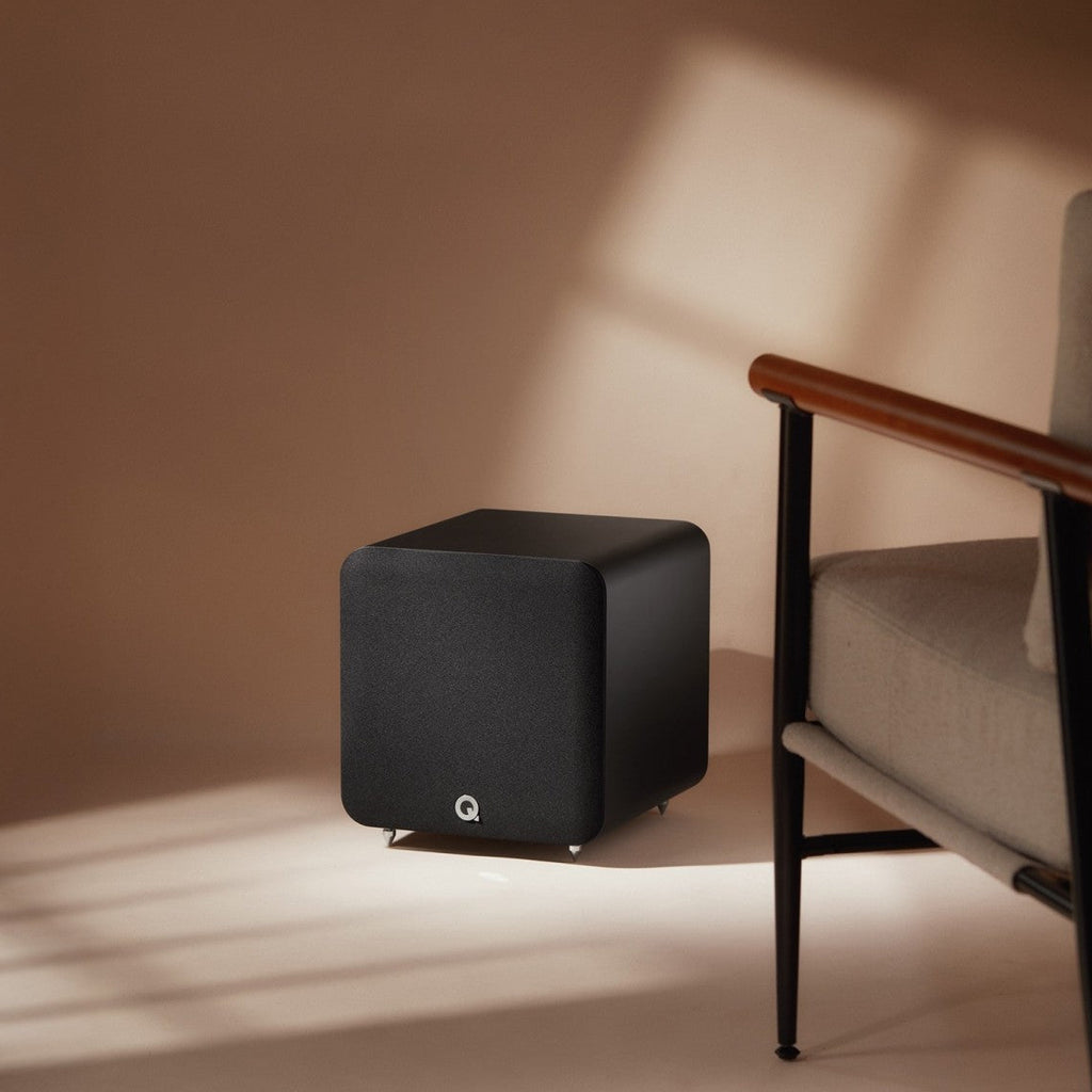 Q Acoustics Q SUB80 subwoofer with sleek black cabinet and front-firing speaker, designed for deep bass and home audio enhancement.