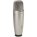 Samson C01U Pro USB microphone with black body and metal grille, set on a desk for professional audio recording.